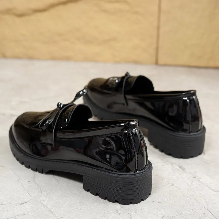 Women's brown and black bow-detailed flat loafers made from artificial PU, shown from the side.