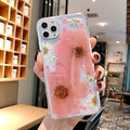 Pink and yellow floral pattern TPU back cover case for iPhone on a white background.