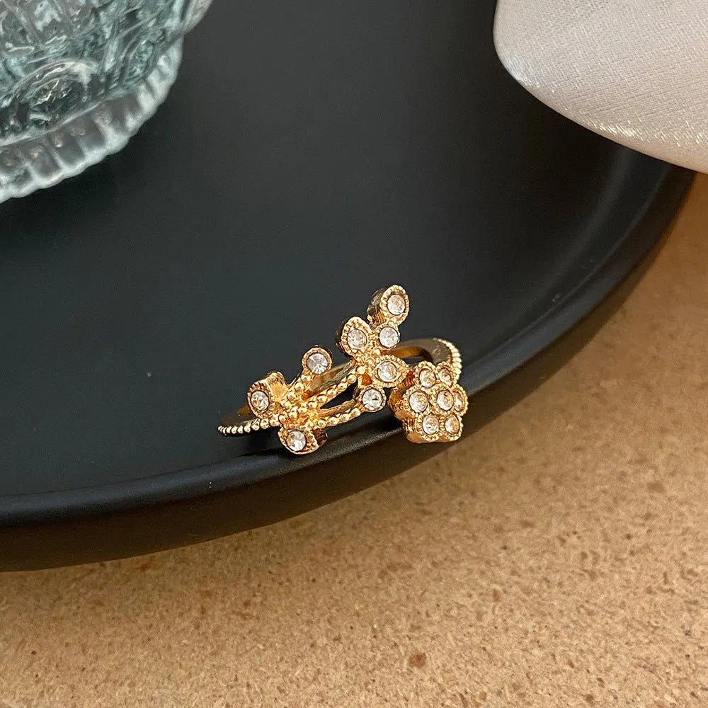 Women's open ring with diamond-treated flower and leaf designs on copper in gold colour option