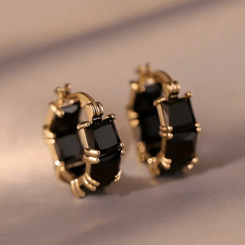 Geometric U-shaped gold earrings with round accents and black zircon stones