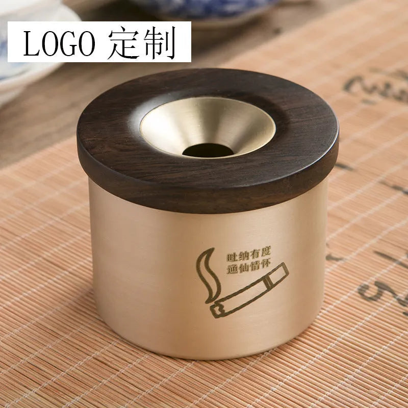 Brass ashtray with wooden lid in copper construction showing centre hole design
