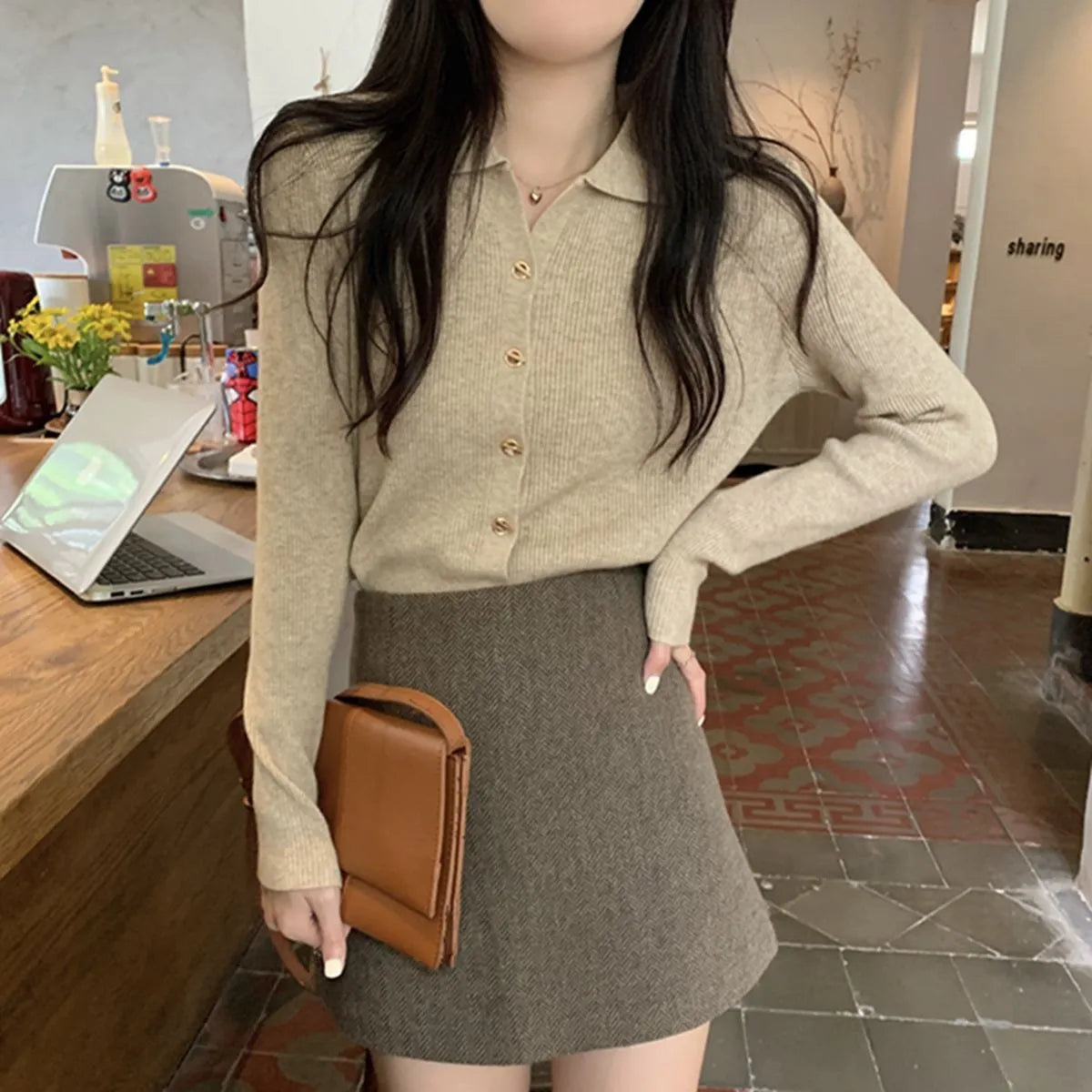 Beige loose fit long-sleeved viscose knitted cardigan top worn open as a layer.