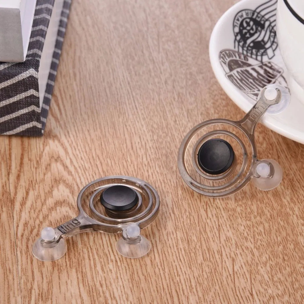 A pair of clear and black mini joysticks for mobile phone touch screen gaming control.