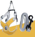 Green adjustable mesh dog harness with reflective strips and a metal leash ring, shown on a dog.