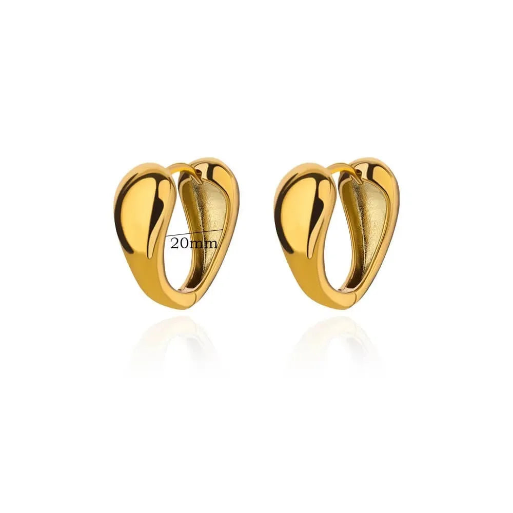 Close-up of women's geometric butterfly drop earrings with heart, star, and bow shapes in copper.