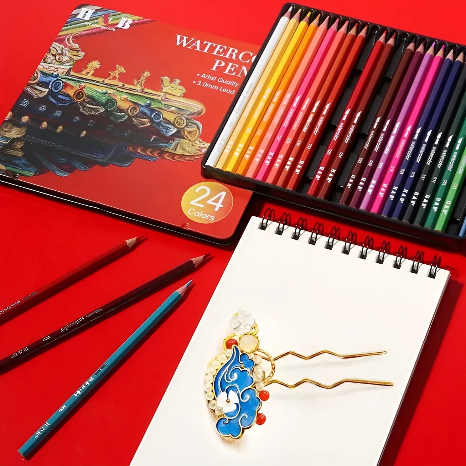 Wooden box open showing 24 water-soluble coloured pencils in various colours.