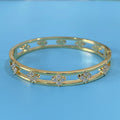 Women's hollow bracelet with four-leaf clover charm and zircon stones in gold or silver
