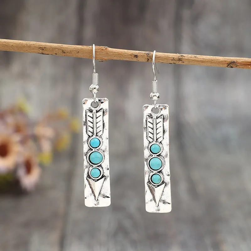 Silver geometric earrings with long strip design and turquoise inlay details