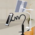 Black flexible mount holder with suction base holding a tablet at adjustable angle