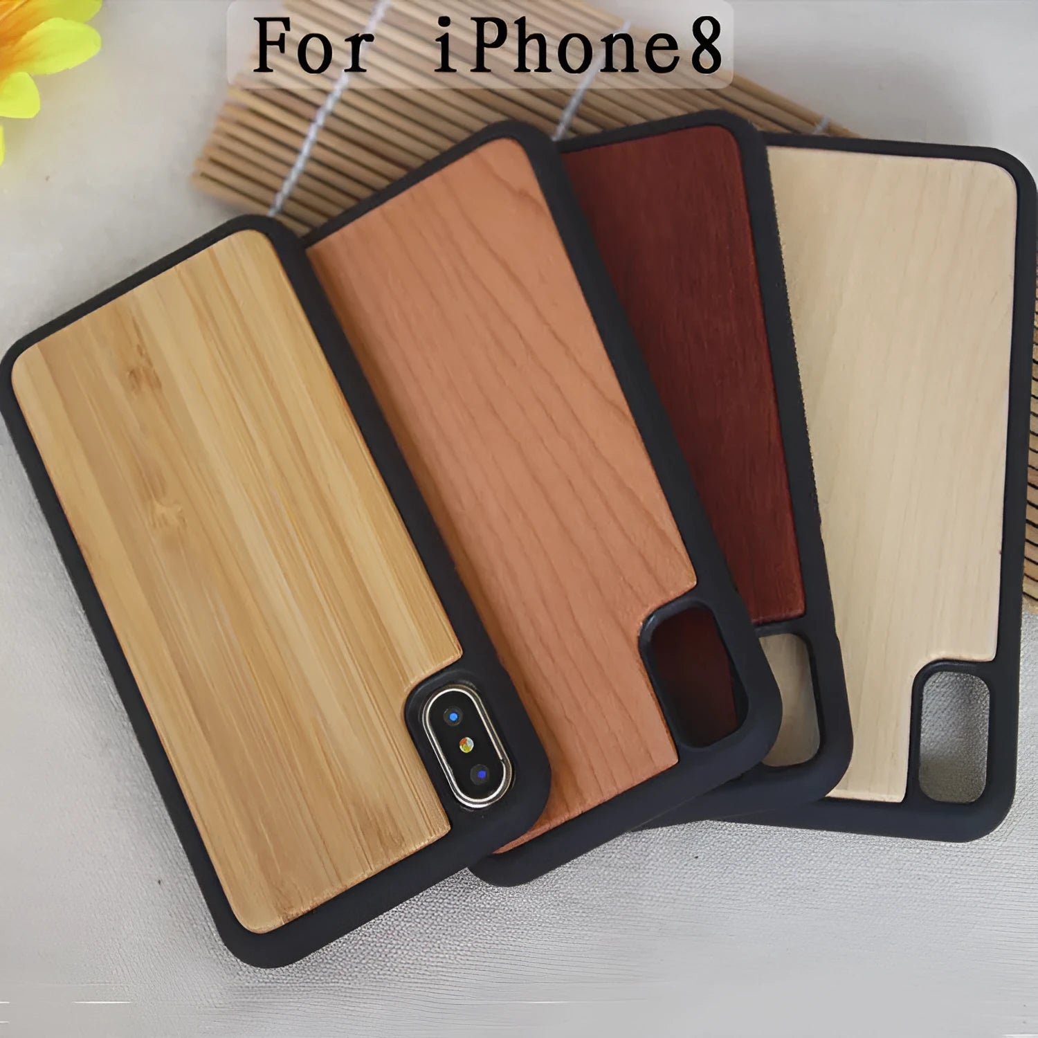 Wooden iPhone case with carbonized bamboo back and black TPU bumper frame on a table.