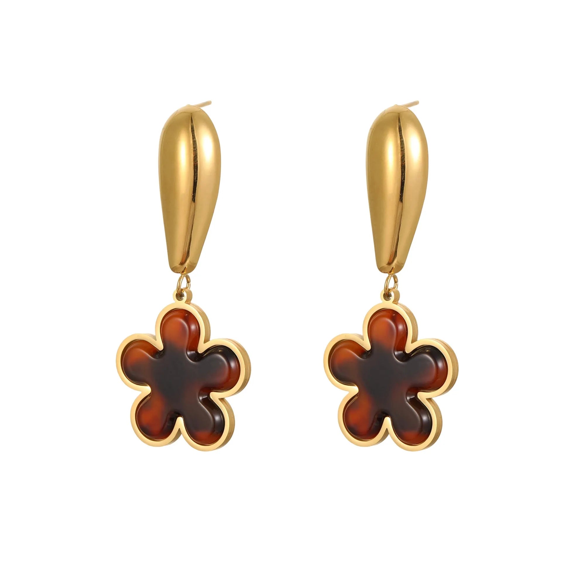 A pair of gold-coloured geometric earrings with a heart shape and a floral design on a white background.