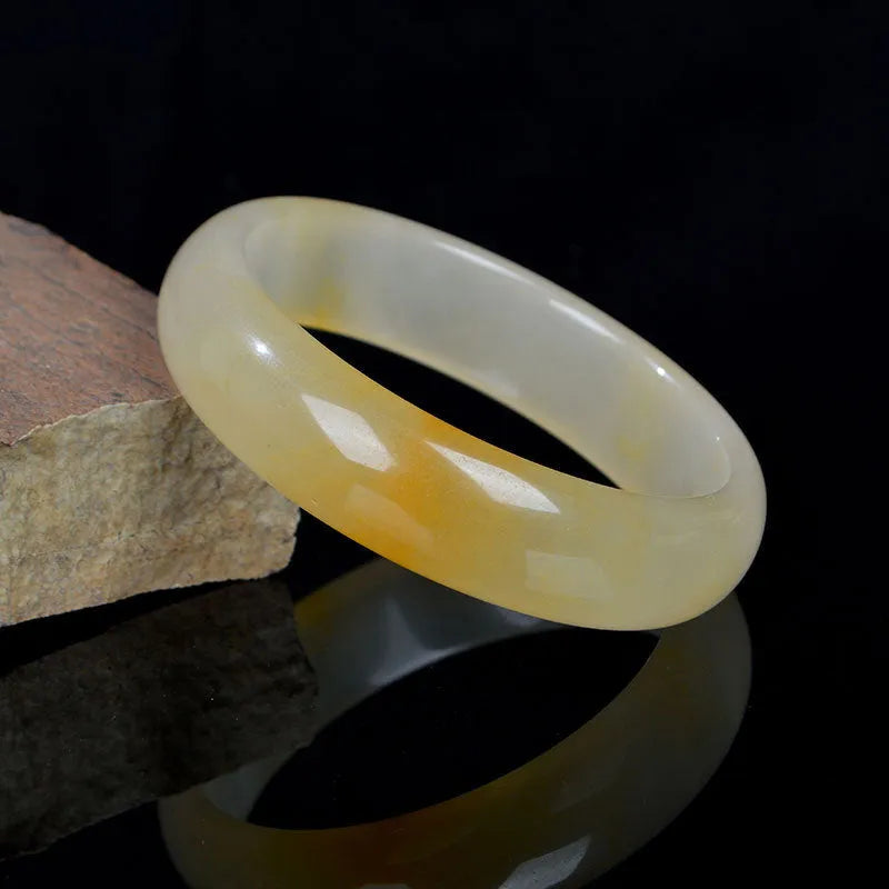 Natural light jade Chinese style bracelet on a white background showing polished finish.
