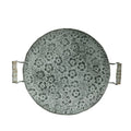 Round wrought iron storage tray in a classic metal colour on a wooden surface.