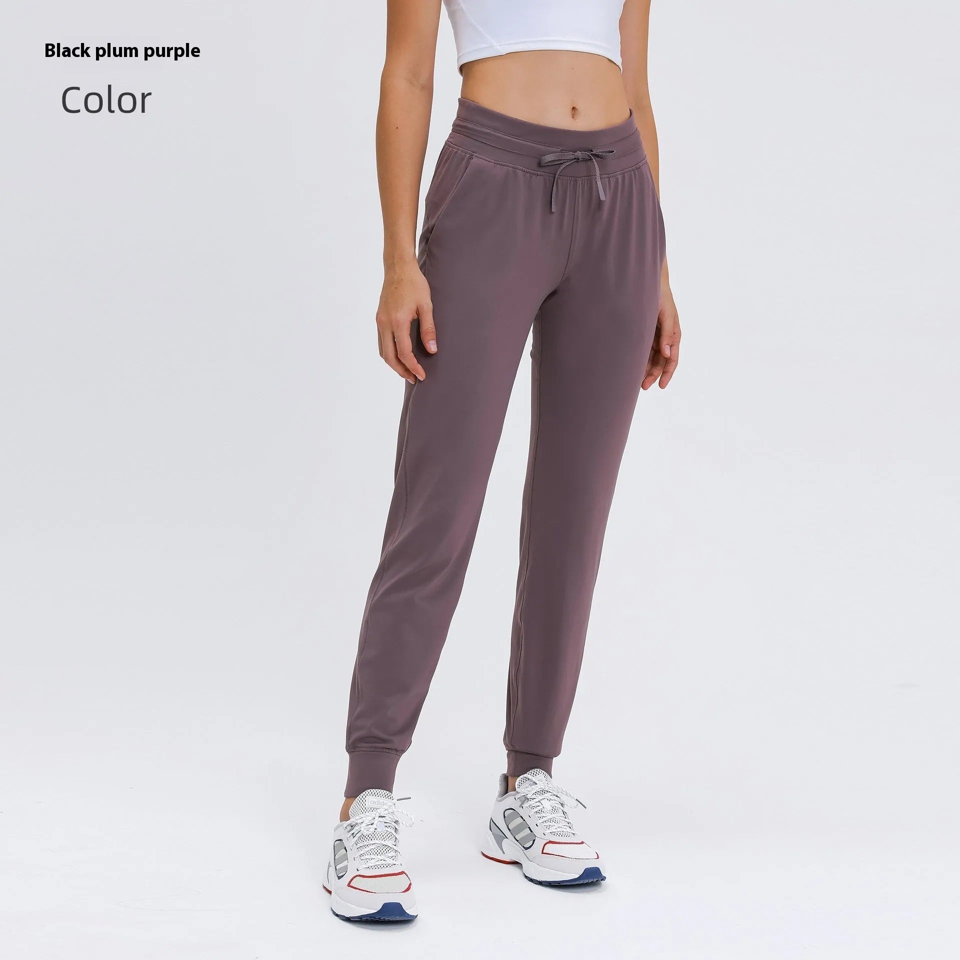 Women's high-waist yoga pants with drawstring waistband in a cotton blend fabric.