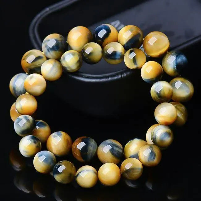 Fantasy tiger eye agate stone bracelet with round beads in geometric pattern on wrist.