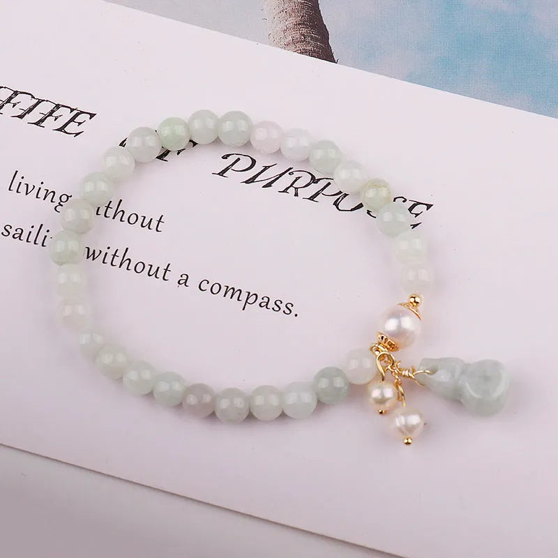 Chinese style jade bracelet with gourd design on woman's wrist