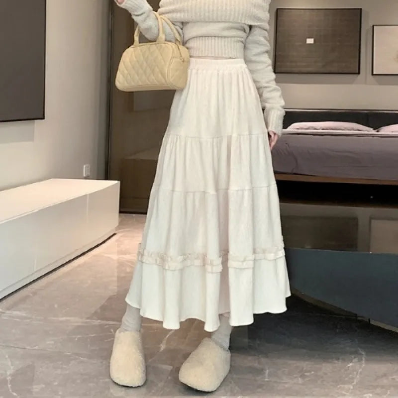 Women's beige corduroy A-line midi skirt with elastic waistband laid flat