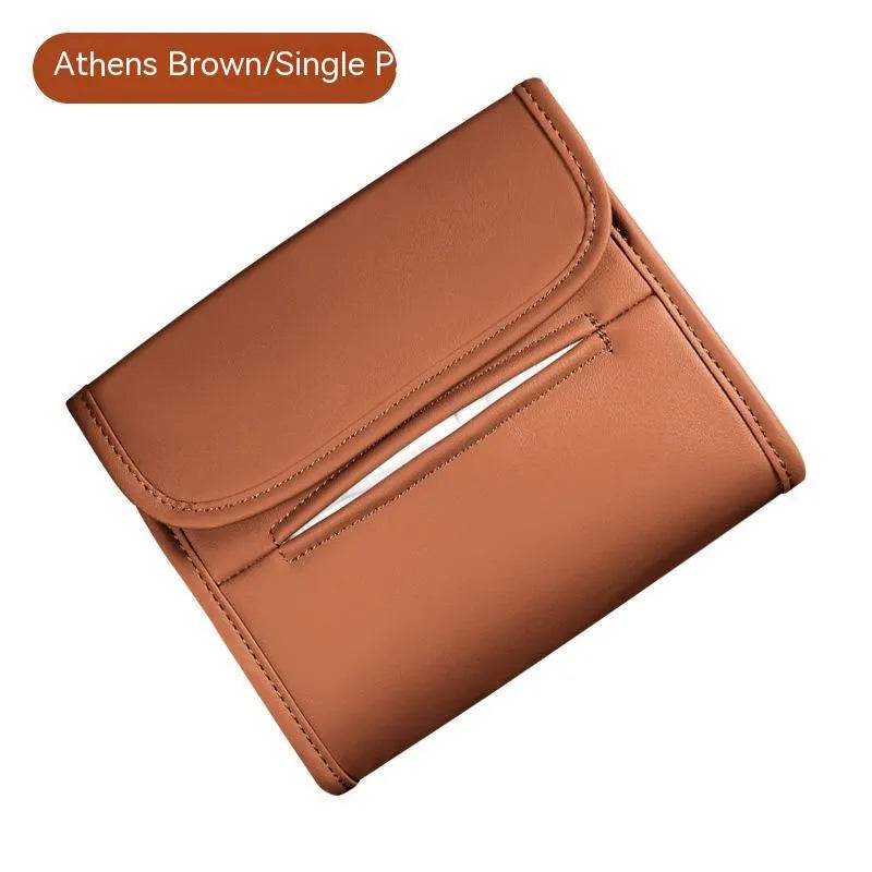 Leather car tissue box mounted on a car sun visor with elastic band strap.