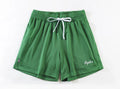 Men's double-layer mesh sports shorts in various colours on a size chart background.
