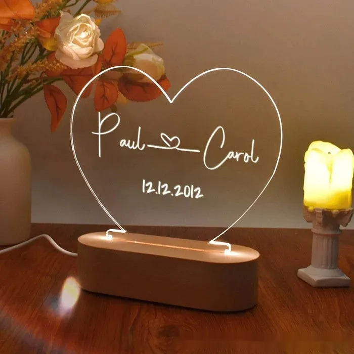 Custom transparent acrylic night light engraved with names, lit by LED base, dimensions 20cm by 11.5cm.