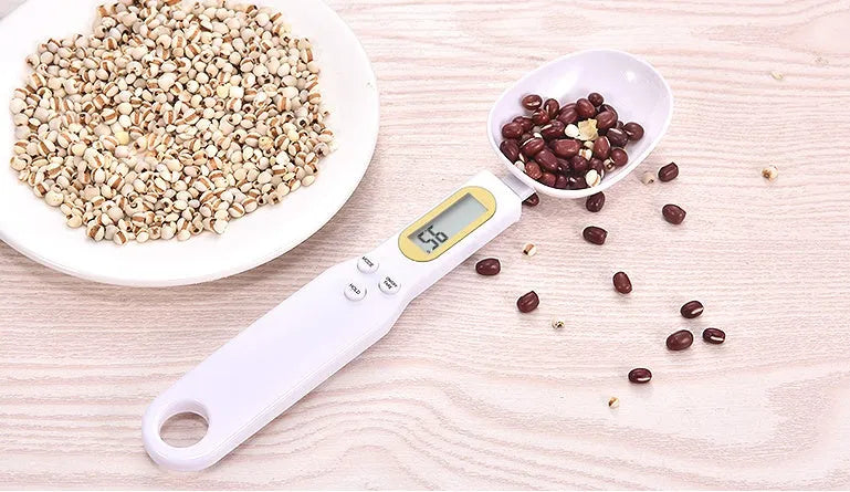 Black electronic measuring spoon scale showing digital display, 23.2cm long.