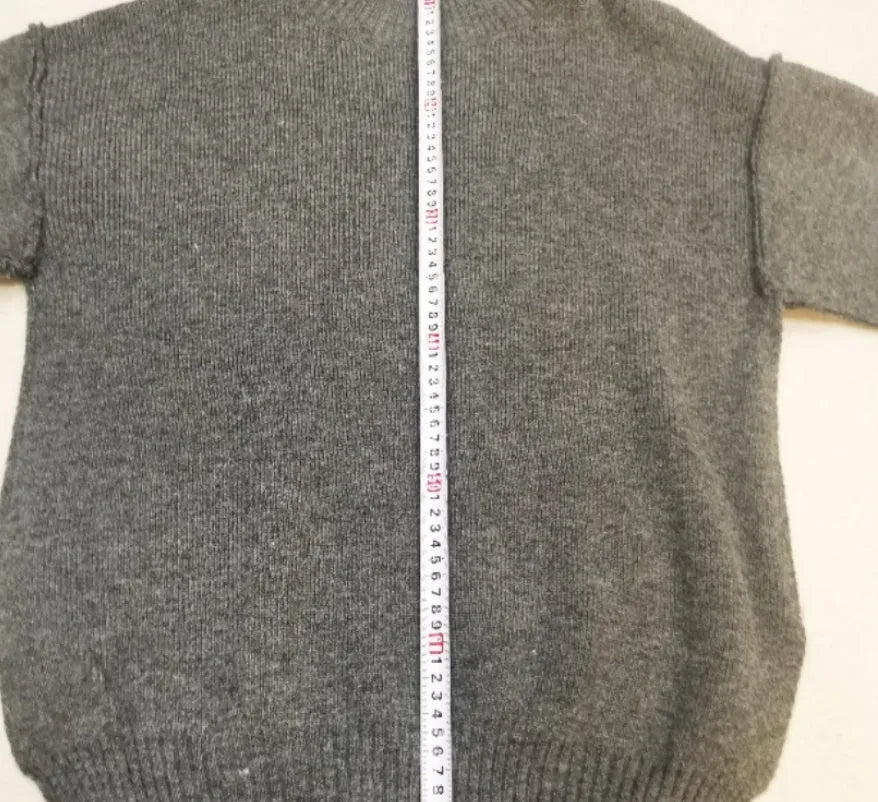 Women's dark grey side-slit sweater and trousers suit set on a hanger