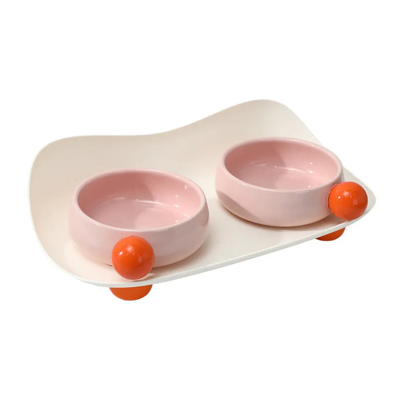 Ceramic elevated pet feeding bowl set with two bowls and non-slip base in pink colour