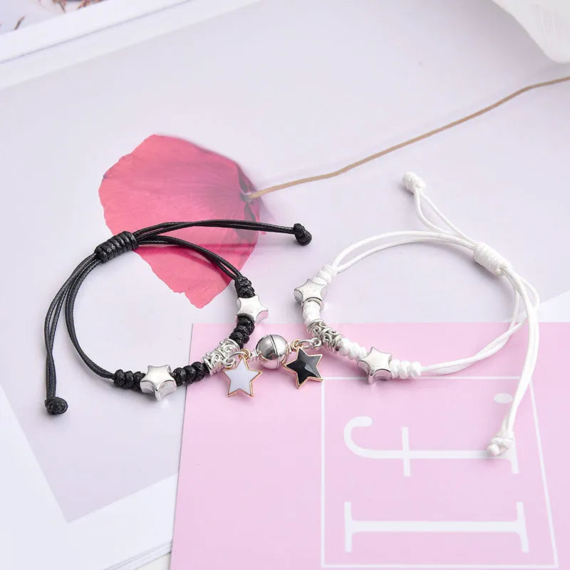 Alloy couple bracelets with magnet closure showing various design options including crown, clover, and text patterns