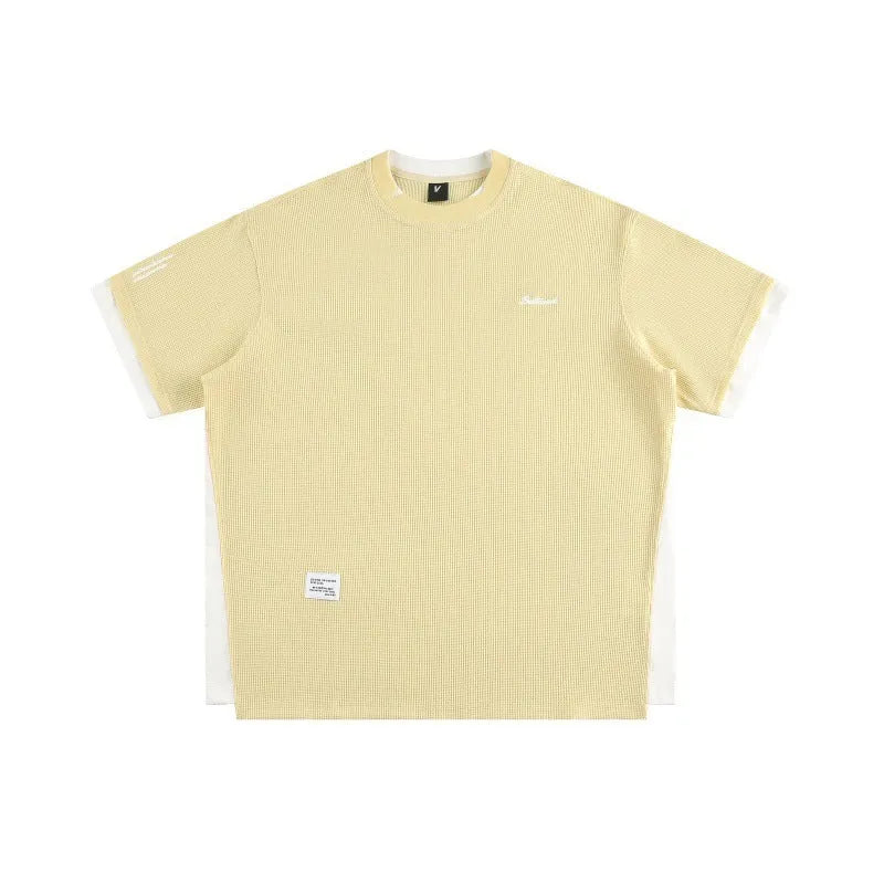 Loose-fit short-sleeved T-shirt with embroidered retro alphabet design on waffle-textured fabric.