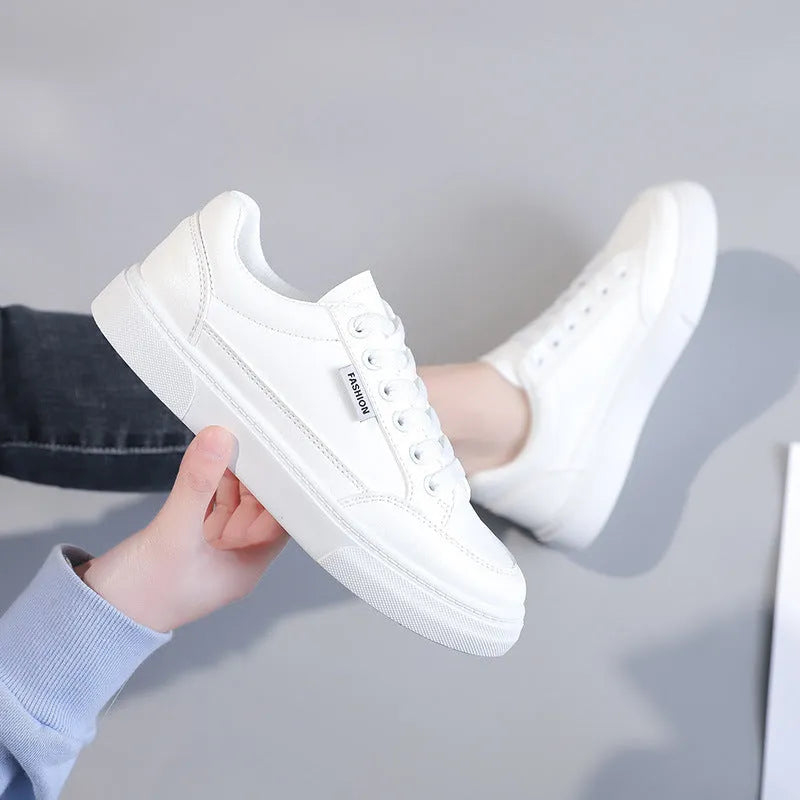 Women's low-top Korean style sneaker in white or brown artificial PU leather with a plastic sole.