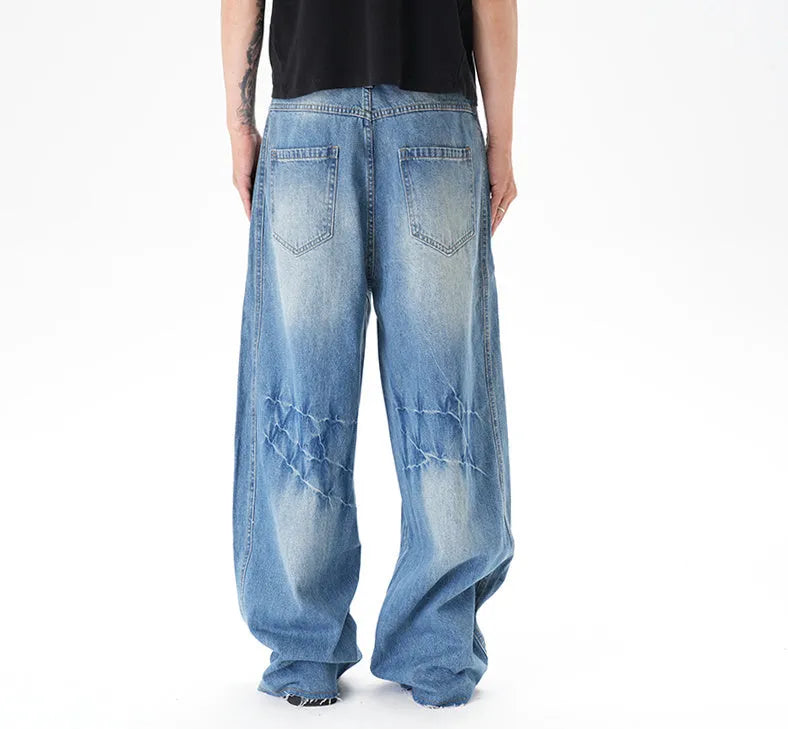 Light blue washed vintage women's wide leg jeans with a machete cut design on a front zip fly.
