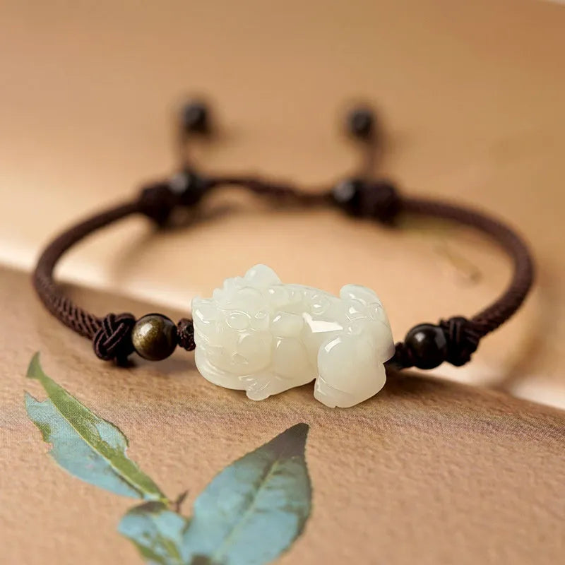 Hetian Jade bracelet with a black and red braided rope band and a central jade bead.