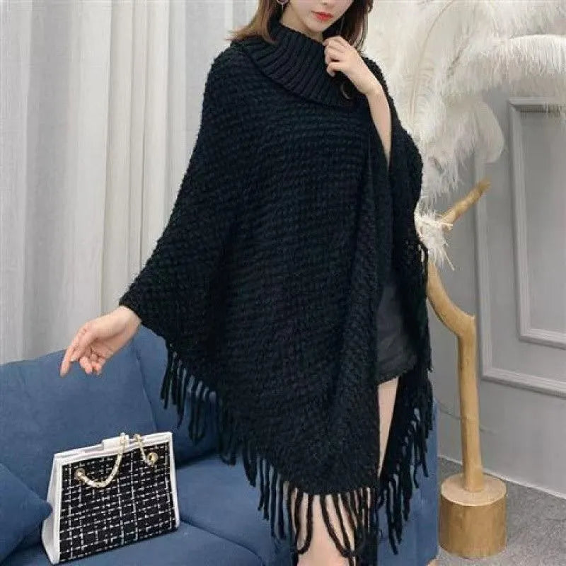 Women's triangular plush shawl cape with tassels in a cashmere and acrylic blend fabric.