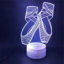 3D ballet dancer silhouette LED night light glowing in purple on a black base with remote control.