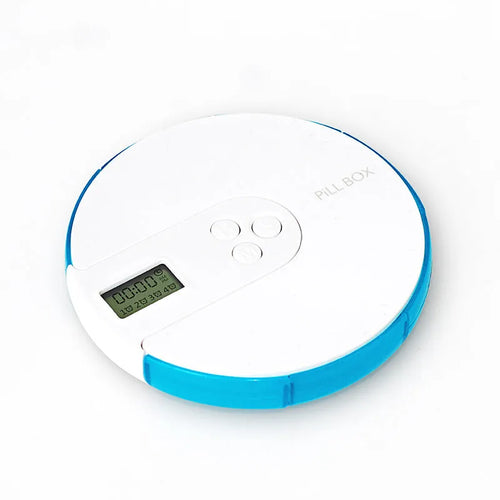 Blue 7-compartment alarm clock pill dispenser showing digital display and pill slots.