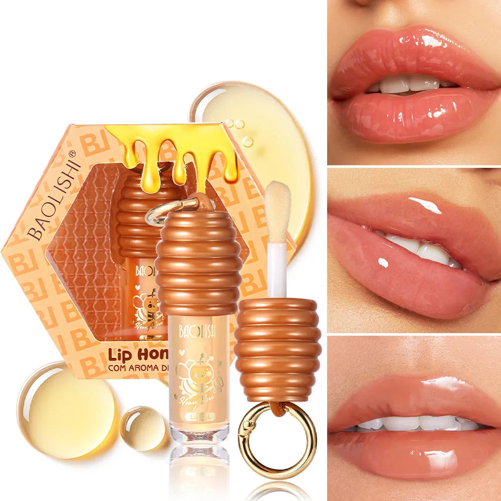 Portable honey lip gloss canister with keychain attachment for moisturising and nourishing lips.