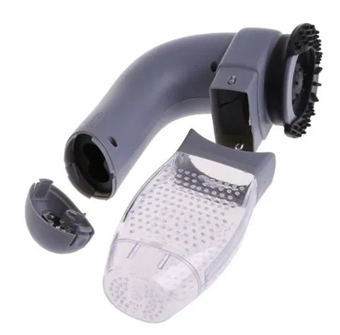 Grey handheld electric pet hair remover brush with soft rubber head, shown removing fur from upholstery.