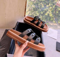 Women's brown retro Roman style sandal slippers with a sheepskin upper and patent leather finish.
