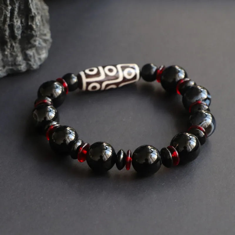 Black agate dzi bead bracelet with geometric pattern and hand-woven construction