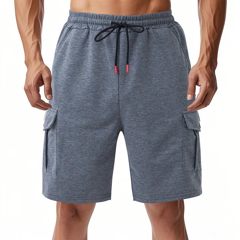 Man's light grey loose-fit cargo shorts made from heavy towel fabric with multiple pockets.
