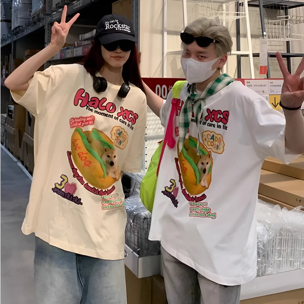 White short-sleeved cotton T-shirt with a cartoon print of a hamburger dog, showing a round neck and loose fit.