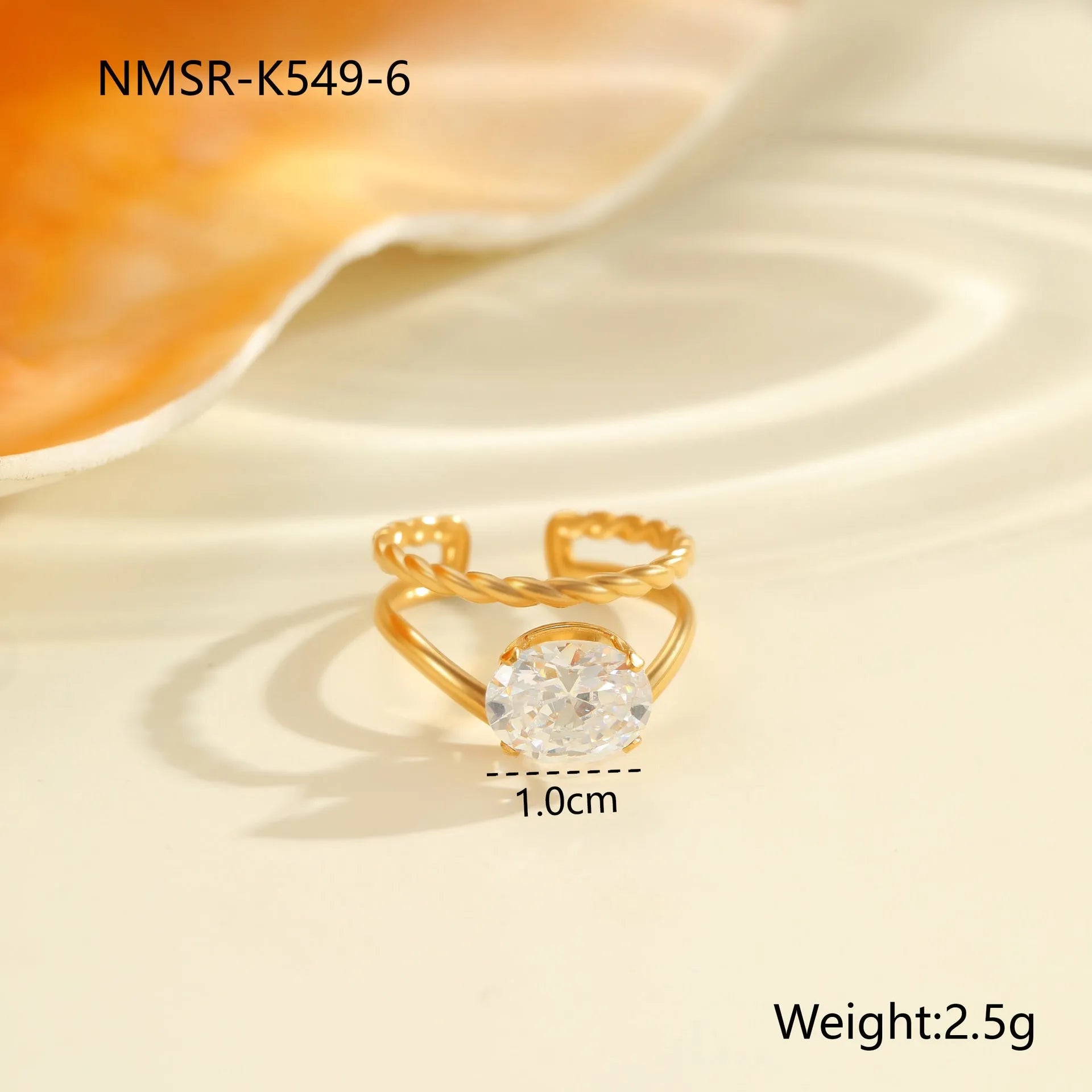 Gold-coloured stainless steel open ring with zircon stones in a geometric heart design.