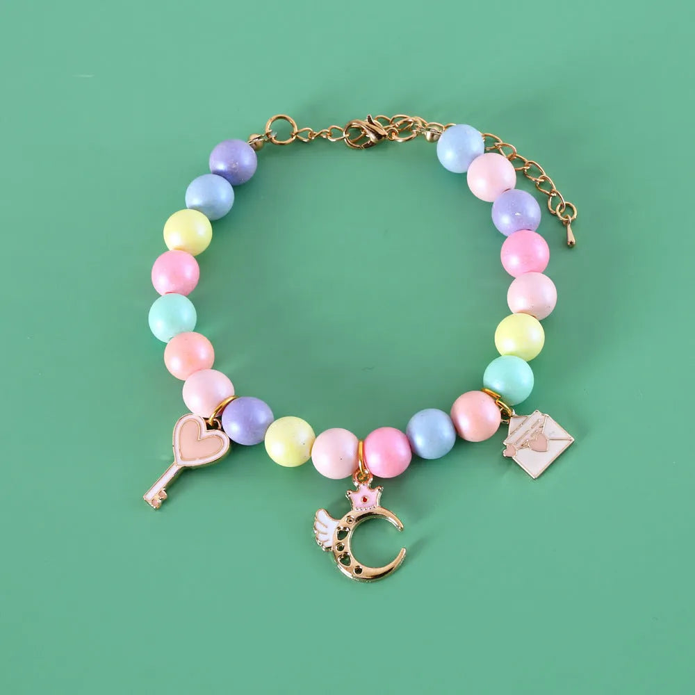 Macaron-colour pet collar with moon and pearl resin charms and a matching bracelet.