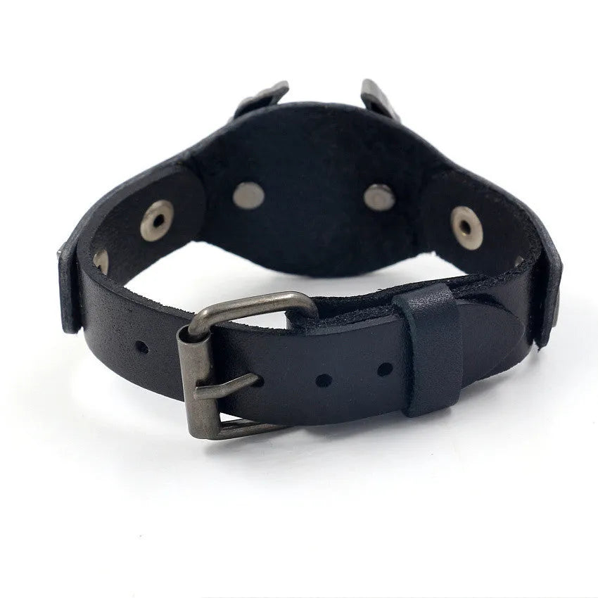 Black geometric leather bracelet with a silver watch-button clasp on a unisex wrist.