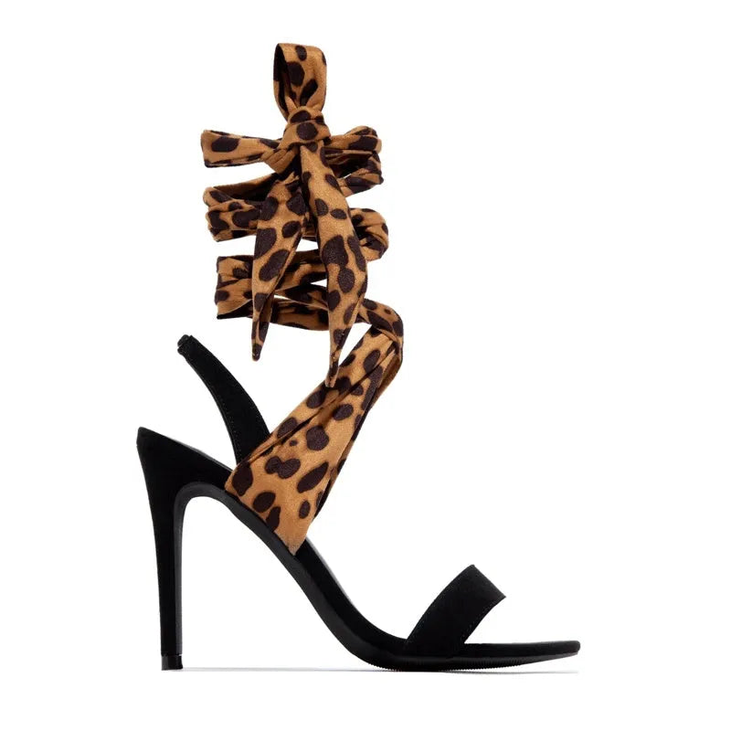 Light brown leopard print women's high heel sandals with cross straps and a thin high heel