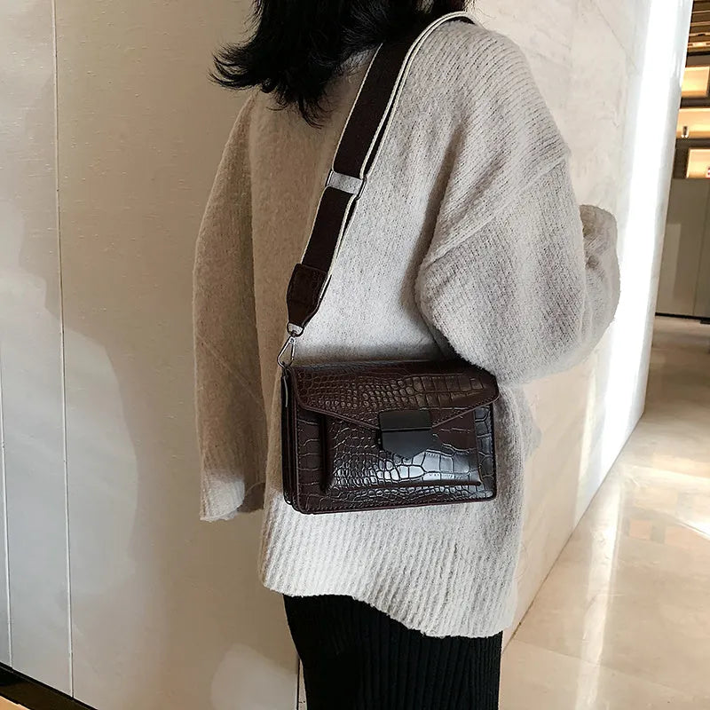 Vintage-style black PU leather crossbody bag with dimensions 20cm by 14cm by 7cm.