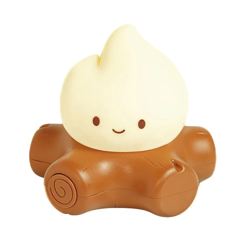 Small Fire Pile cartoon-themed silicone night light with yellow glow on a table.