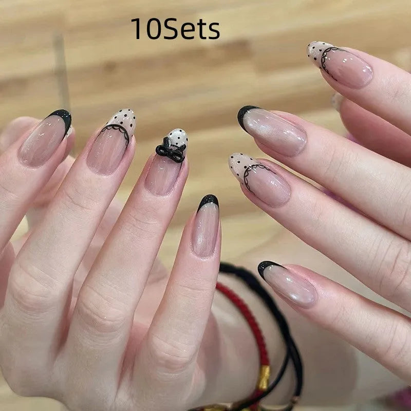 Set of colourful press-on false nails for girls with adhesive tabs on a white background.