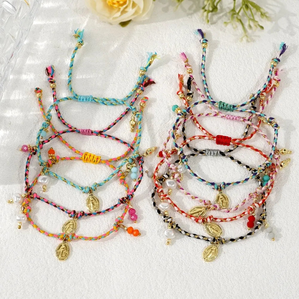 Close-up of a hand-woven colourful braided rope bracelet with a leather closure and strap tag detail.