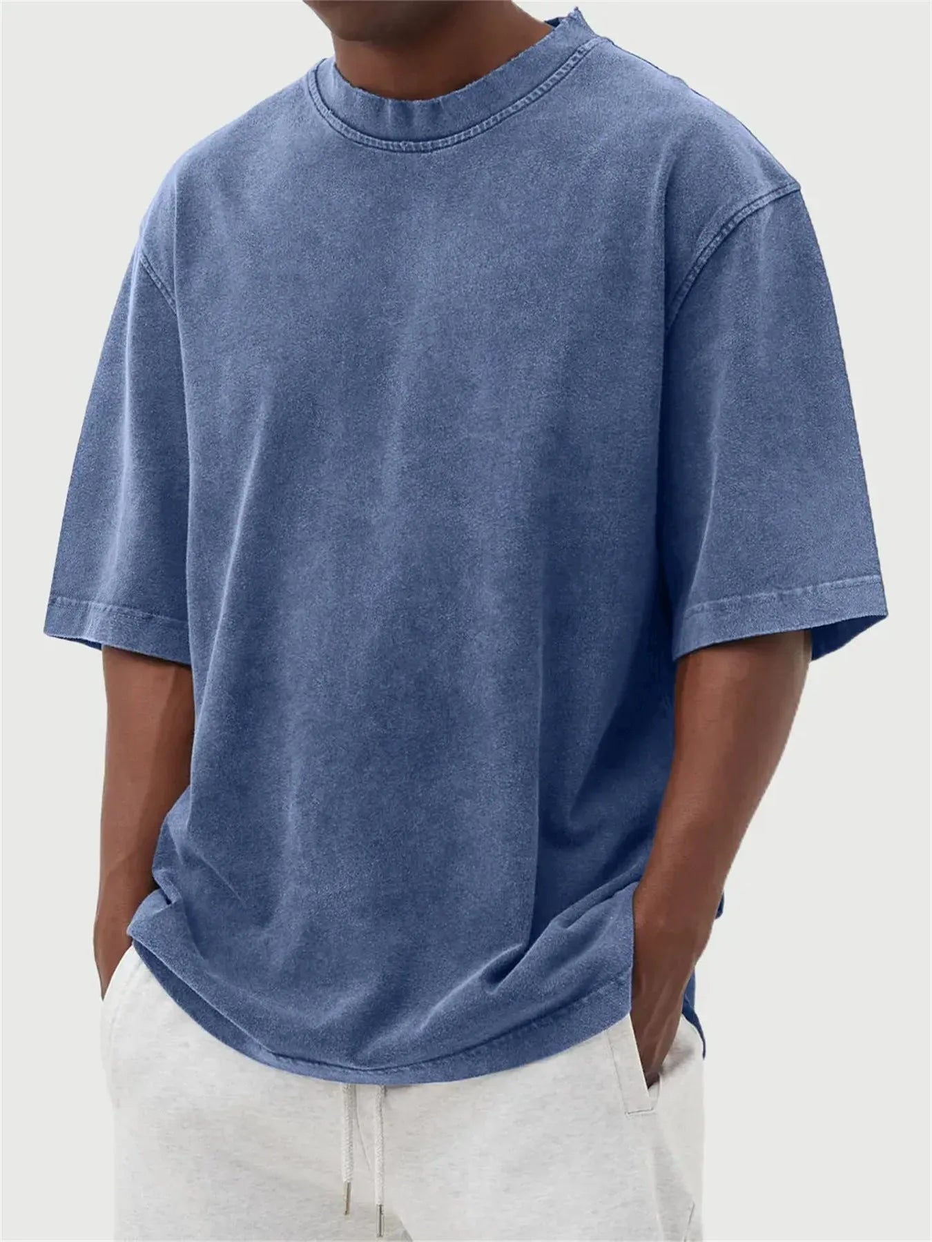 Men's loose fit pullover T-shirt in a stone-washed distressed solid colour, shown in army green.